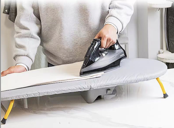 Foldable table top ironing board with iron holder