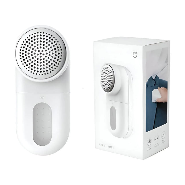 A white lint remover device shown next to its white retail box on a clean white background. The device has a circular lint-catching head and a transparent water collection window on the front. peeta-best online uae store