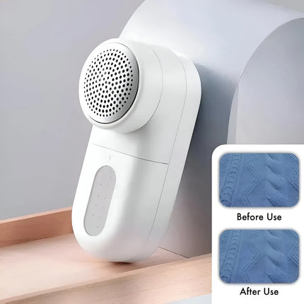 A white lint remover brush with a circular cleaning head and oval charging port, shown leaning against a curved white surface on a wooden ledge. A small inset at the bottom right shows a before-and-after comparison of textured blue fabric cleaned by the device. peetta-Lint_Remover_Efficient_Fabric_Shaver_and_Lint_Roller_for_Clothes_and_Upholstery-best_online_store_uae_4