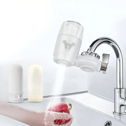 Water filter attachment on a faucet with water flowing over a red pepper..peetta-best online uae store