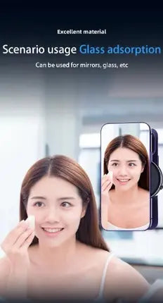 A promotional graphic for a glass adsorption mirror, showing a woman applying makeup in front of a mirror, with a phone screen inset displaying the reflected image. Text at the top reads 'Excellent material' and 'Scenario usage Glass adsorption' with 'Can be used for mirrors, glass, etc.peetta-VacuumSuctionCarMount-MagneticUniversalPhoneHolder1